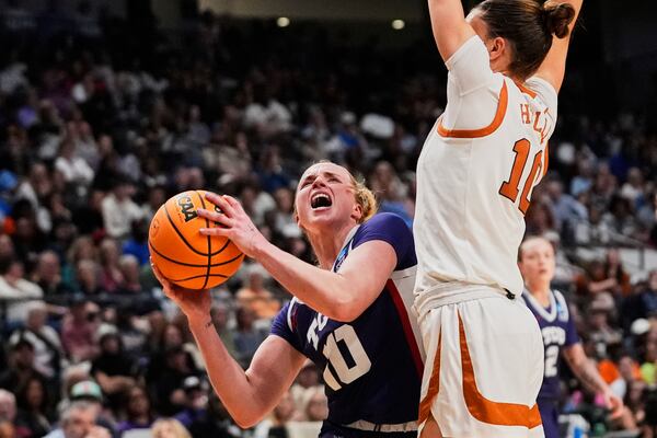 TCU guard Hailey Van Lith (10) goes to the basket agains Texas guard Shay Holle (10) during the second half in the Elite Eight of the NCAA college basketball tournament, Monday, March 31, 2025. in Birmingham, Ala. (AP Photo/Gerald Herbert)