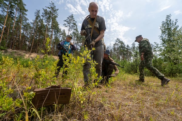 Civilians practice military skills on a training ground in Kharkiv, Ukraine, Saturday, July 12, 2025. (AP Photo/Andrii Marienko)