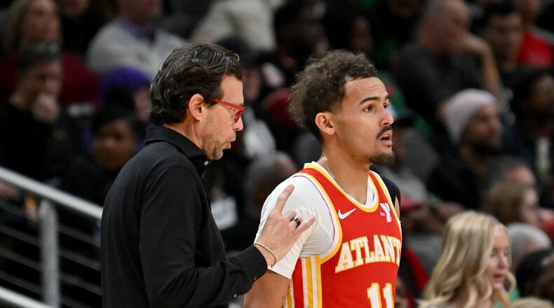Atlanta Hawks head coach Quin Snyder confers with Atlanta Hawks guard Trae Young (11) during the second half in an NBA basketball game at State Farm Arena, Wednesday, December 3, 2024, in Atlanta. Atlanta Hawks won 141-138 over Oklahoma City Thunder. (Hyosub Shin / Hyosub.Shin@ajc.com)