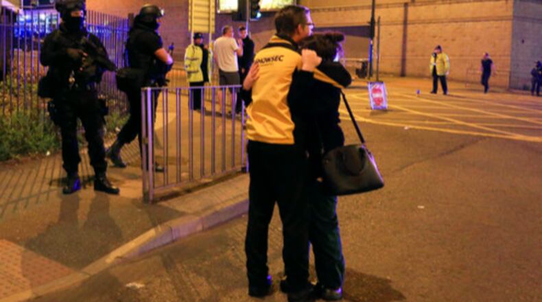 Armed police stand guard at Manchester Arena after reports of an explosion at the venue during an Ariana Grande gig in Manchester, England Monday, May 22, 2017. Police says there are "a number of fatalities" after reports of an explosion at an Ariana Grande concert in northern England. (Peter Byrne/PA via AP)