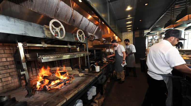 The focal point at King + Duke is a massive open hearth fueled by crackling firewood and hardwood charcoal. (Becky Stein for The Atlanta Journal-Constitution)