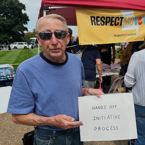 FILE - John Billman, of Columbia, Mo., holds a sign explaining his opposition to a state legislative proposal that would make it harder for voters to approve citizen-initiated constitutional amendments while rallying at the state Capitol in Jefferson City, on Wednesday, Sept. 10, 2025. (AP Photo/David A. Lieb, File)