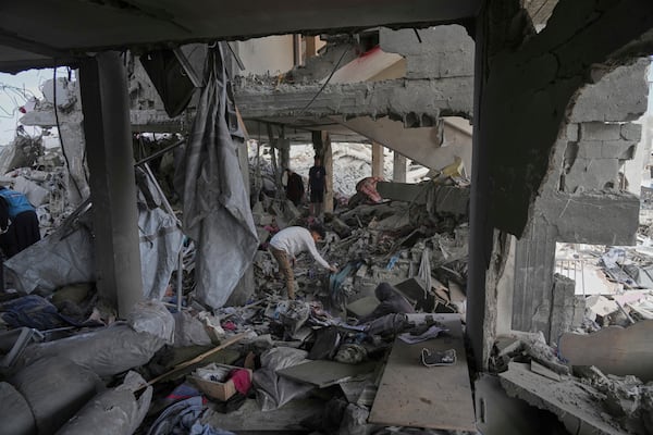 Palestinians look at the damage after an Israeli army airstrike in Beit Lahia, northern Gaza Strip, Monday, April 28, 2025. (AP Photo/Jehad Alshrafi)