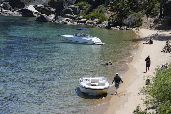 Visitors along the lake at D.L. Bliss State Park after a weekend incident in which a boat capsized, killing several people, on Monday, June 23, 2025, in Lake Tahoe, Calif. (AP Photo/Brooke Hess-Homeier)