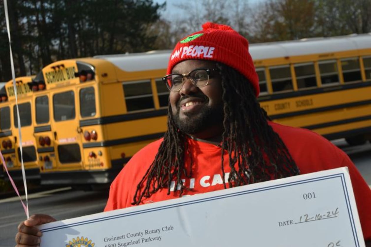Radloff Middle School bus driver Jamario Felder is being hailed a hero for actions he took to save a student who was unconscious on his bus in August. The Rotary Club of Duluth presented its Hidden Hero Award to Felder on Dec. 17. (Photo Courtesy of Curt Yeomans)
