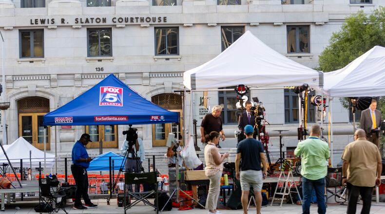 Television news crews line up outside the Fulton County Courthouse on Tuesday in the aftermath of a sweeping criminal indictment that brought charges against former President Donald Trump and 18 others.