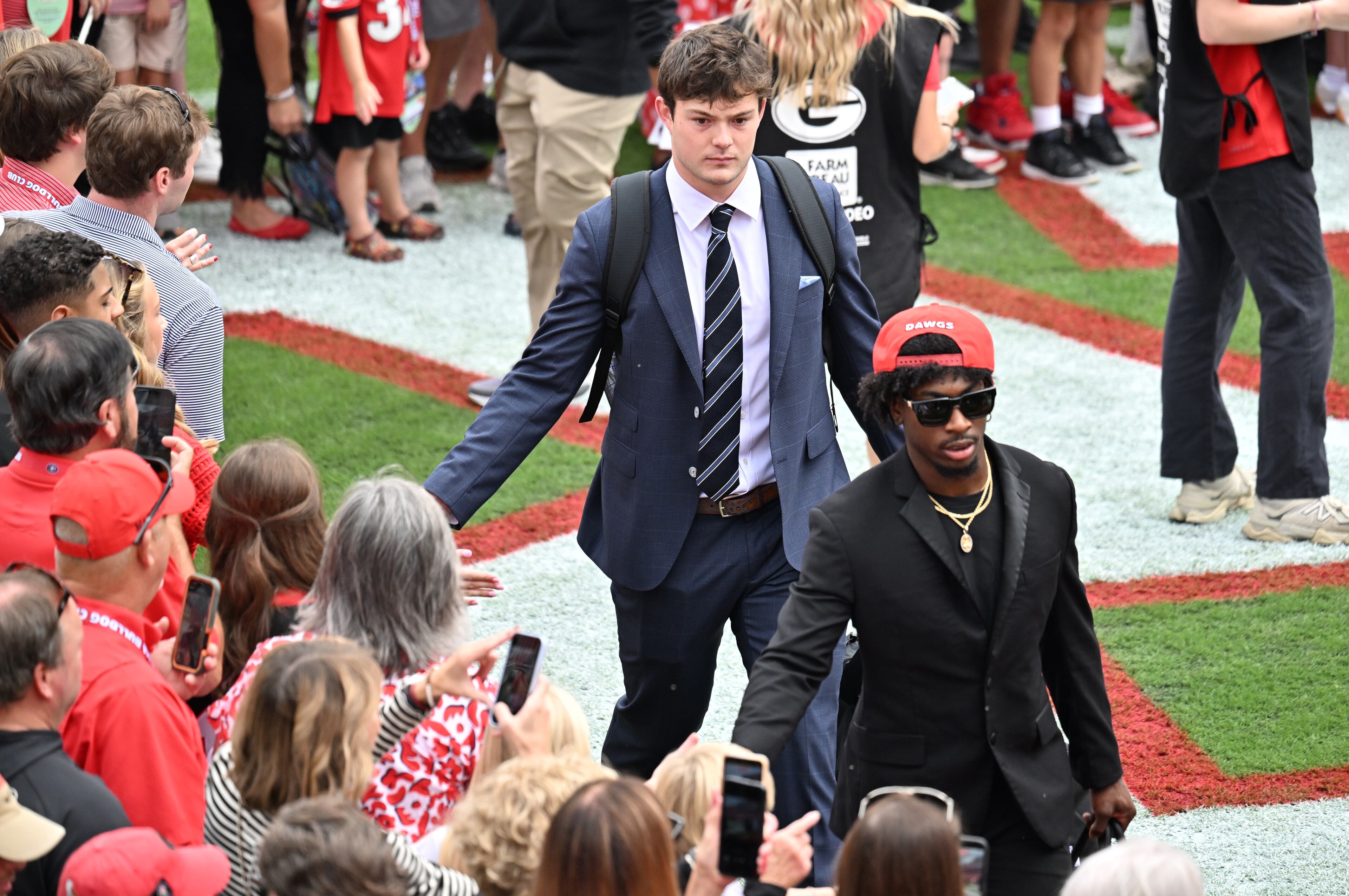 Georgia tight end Oscar Delp and other players arrive during the Dawg Walk before an NCAA football game against Mississippi at Sanford Stadium, Saturday, October 18, 2025, in Athens. (Hyosub Shin/AJC)