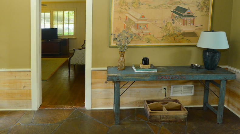 In the foyer of Bernard and Emily Van der Lande’s Atlanta home is a console table that Emily found at A Classy Flea in Marietta. The Van der Landes placed an antique Japanese screen above the console.