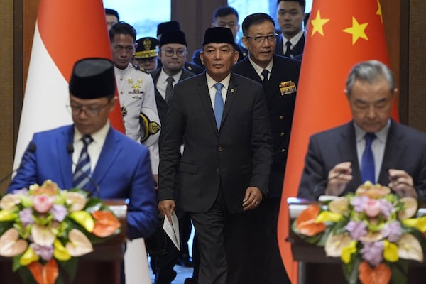 Indonesian Foreign Minister Sugiono, bottom left, Indonesian Defense Minister Sjafrie Sjamsoeddin, center left, Chinese Defense Minister Dong Jun, center right, and Chinese Foreign Minister Wang Yi, bottom right, arrive for a press briefing after the first meeting of China-Indonesia joint foreign and defense ministerial dialogue at the Diaoyutai State Guest House in Beijing Monday, April 21, 2025. (Iori Sagisawa/Pool Photo via AP)