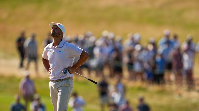 Wyndham Clark reacts to his shot on the ninth hole during the final round of the U.S. Open golf tournament at Shinnecock Hills Golf Club in Southampton, N.Y., Sunday, June 21, 2026. (AP Photo/George Walker IV)