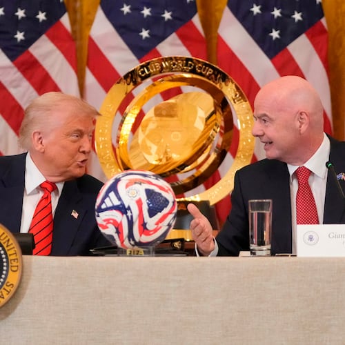 FILE - President Donald Trump and FIFA President Gianni Infantino talk during a FIFA task force meeting in the East Room of the White House, May 6, 2025, in Washington. (AP Photo/Mark Schiefelbein, File)