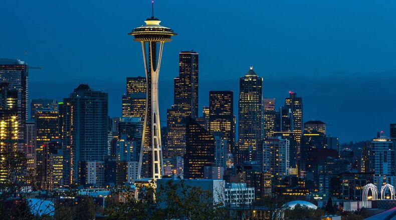The sun sets on the Space Needle and downtown skyline as viewed at dusk in Seattle, Washington. Seattle, located in King County, is the largest city in the Pacific Northwest. (Photo by George Rose/Getty Images)