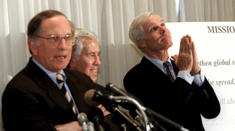 Ted Turner, then a vice-chairman at AOL Time Warner, right, “prays” during a 2001 press conference at the National Press Club in Washington that launched the Nuclear Threat Initiative with former Georgia Sen. Sam Nunn, left. AP /Michael DiBari Jr.