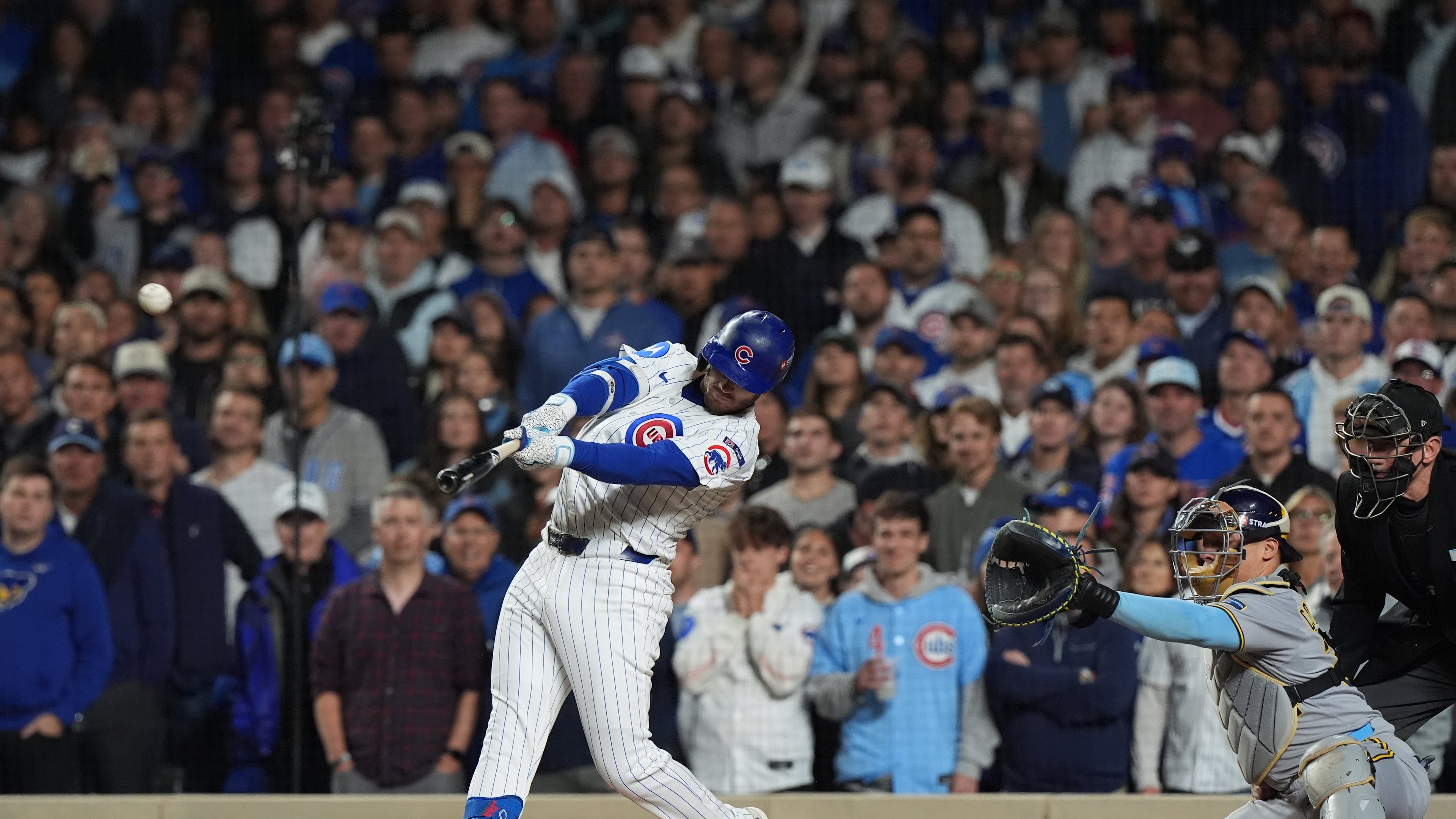 Chicago Cubs' Ian Happ (8) hits a 3-run home run during the first inning of Game 4 of baseball's National League Division Series against the Milwaukee Brewers Thursday, Oct. 9, 2025, in Chicago. (AP Photo/Nam Y. Huh)