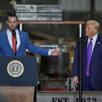 Former Floyd County District Attorney Clay Fuller (left) speaks as President Donald Trump listens during a rally at Coosa Steel Corp. on Thursday, Feb. 19, 2026, in Rome. Fuller won the special election to replace Marjorie Taylor Greene in Georgia’s 14th Congressional District. (George Walker IV/AP)
