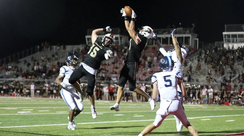 GAC defensive back Will Hardy (5) intercepts a pass intended for Lovett wide receiver Andrew Pinkston (2) as Joseph Rose (15) and Lovett's Logan Givens (5) are shown on the play at the end of the game Friday in Norcross. The interception ended Lovett's scoring threat and secured the 10-3 victory for GAC. (Jason Getz/Special to the AJC)