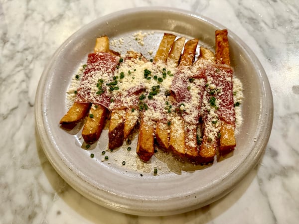 The prosciutto-wrapped truffle fries at Bar Pilar are both decadent and comforting. (Angela Hansberger for the AJC)