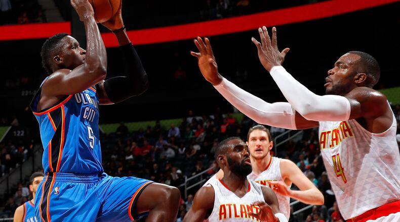 Victor Oladipo of the Oklahoma City Thunder drives against Paul Millsap of the Atlanta Hawks at Philips Arena on December 5, 2016 in Atlanta, Georgia. (Photo by Kevin C. Cox/Getty Images)