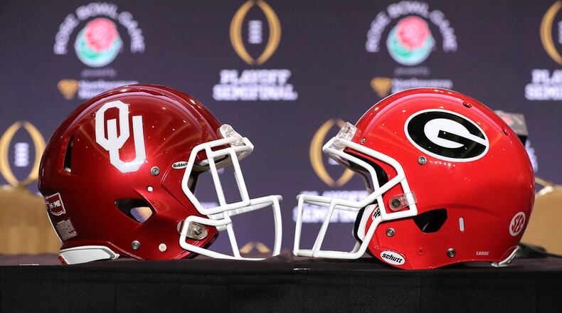 The Georgia and Oklahoma helmets sat side-by-side on a  table during Rose Bowl press conferences in Los Angeles.