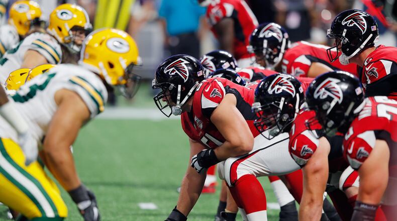 Falcons center  Alex Mack (center) prepares to snap the ball during the second half against the Packers at Mercedes-Benz Stadium on September 17,  in Atlanta.