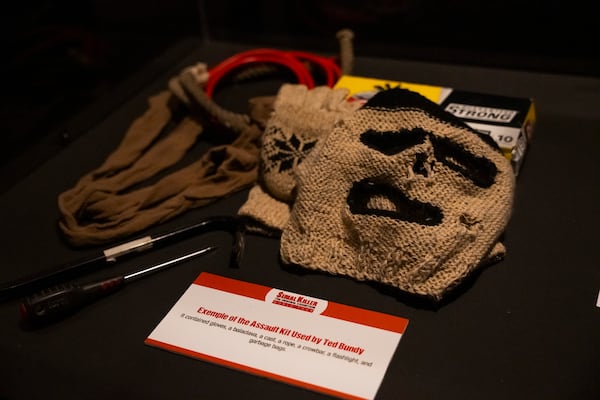 Items from Ted Bundy's assault kit are displayed. The kit contained gloves, a balaclava, rope, a crowbar, a flashlight and garbage bags. (Olivia Bowdoin/AJC)