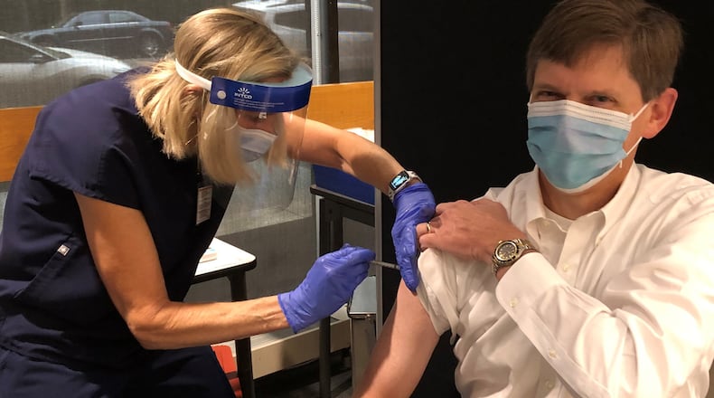 David W. Kimberlin, M.D., a professor of pediatrics in the division of pediatric infectious diseases at the University of Alabama at Birmingham, receives his first dose of COVID-19 vaccine in December 2020, shortly after losing his father to the virus.