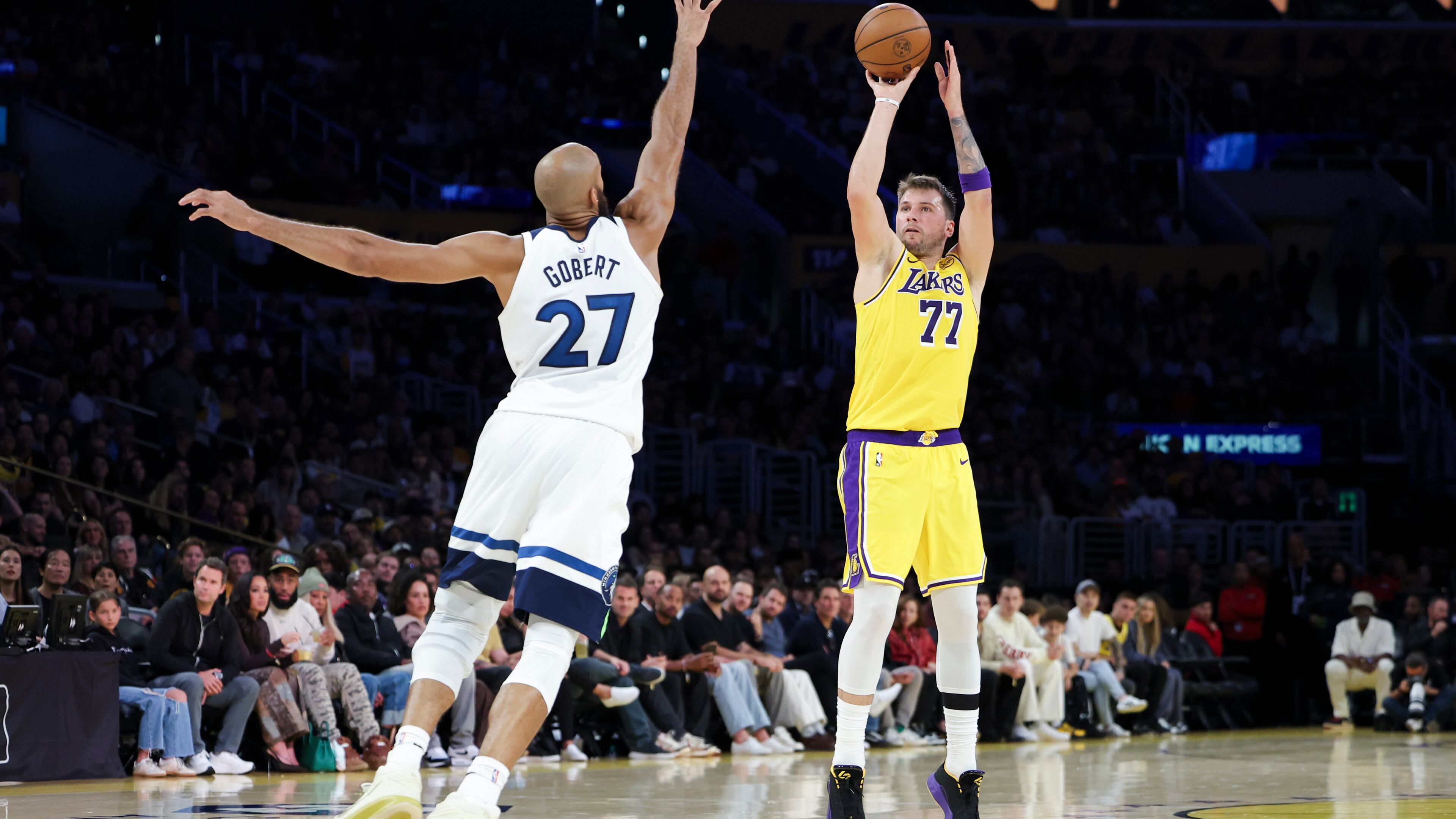 Los Angeles Lakers guard Luka Doncic (77) shoots against the Minnesota Timberwolves center Rudy Gobert (27) during the first half of an NBA basketball game, Friday, Oct. 24, 2025, in Los Angeles. (AP Photo/Jessie Alcheh)
