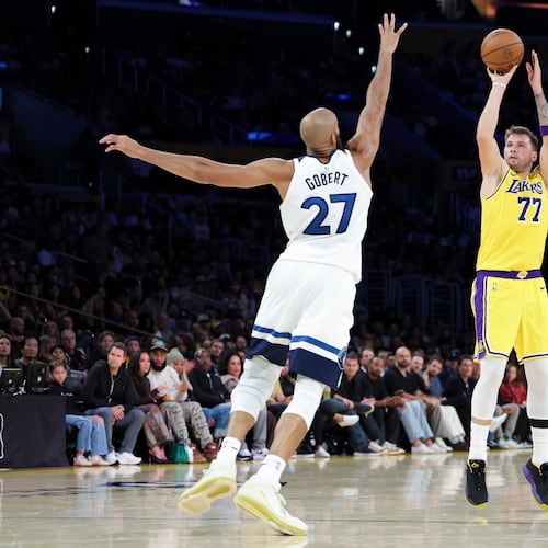 Los Angeles Lakers guard Luka Doncic (77) shoots against the Minnesota Timberwolves center Rudy Gobert (27) during the first half of an NBA basketball game, Friday, Oct. 24, 2025, in Los Angeles. (AP Photo/Jessie Alcheh)
