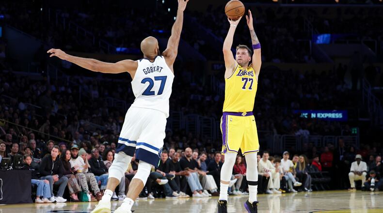 Los Angeles Lakers guard Luka Doncic (77) shoots against the Minnesota Timberwolves center Rudy Gobert (27) during the first half of an NBA basketball game, Friday, Oct. 24, 2025, in Los Angeles. (AP Photo/Jessie Alcheh)