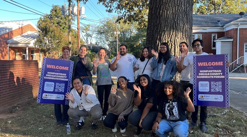Amy Medford (back row, far left) volunteers to keep refugee and immigrant groups informed about happenings around elections and government meetings.