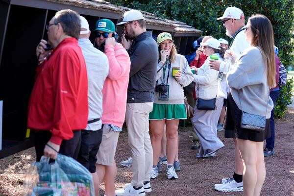 Patrons line up to use courtesy phones during a practice around at the Masters golf tournament, Wednesday, April 9, 2025, in Augusta, Ga. (AP Photo/Ashley Landis)