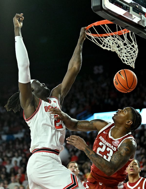 Georgia center Somto Cyril (left) dunks over Arkansas forward Nick Pringle on Saturday, Jan. 17, 2026, at Stegeman Coliseum in Athens. Cyril is averaging 9.6 points, 6.1 rebounds and 2.7 blocks per game. (Hyosub Shin/AJC)