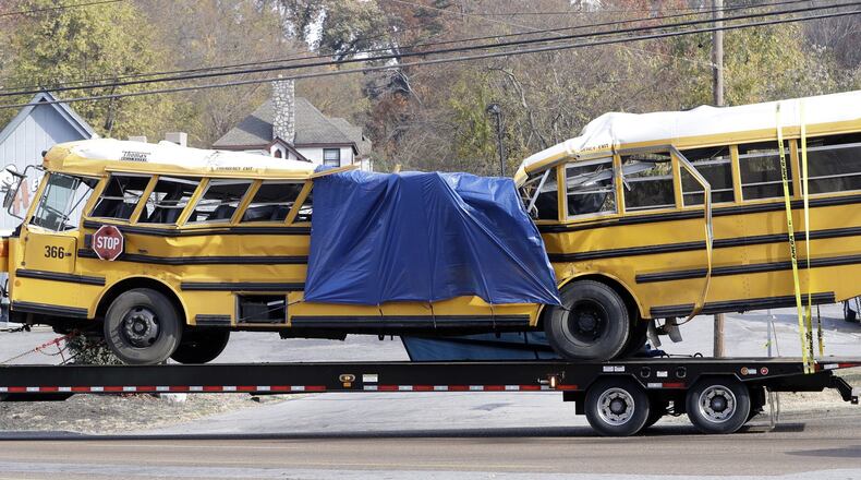 Mounted on a flatbed trailer, Woodmore Elementary School bus 366 is taken away from the crash site on Nov. 21. Six children died aboard the bus when it careened off the road and slammed into a tree and a telephone poll. (AP Photo/Mark Humphrey)