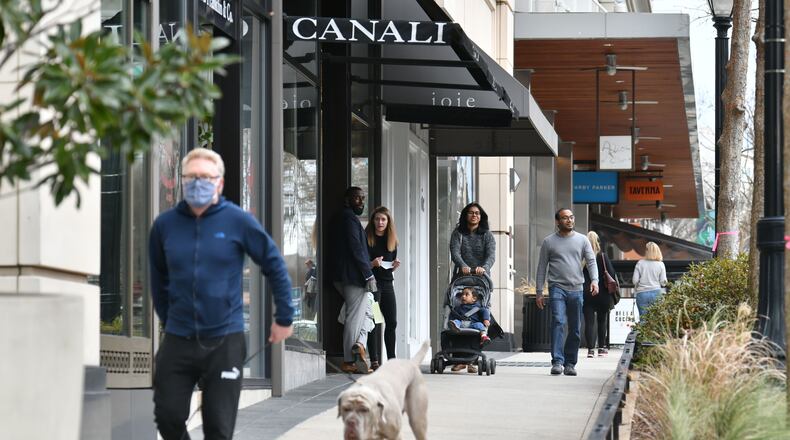 Residents walk near the Buckhead Village shopping center in Buckhead. (Hyosub Shin / Hyosub.Shin@ajc.com)