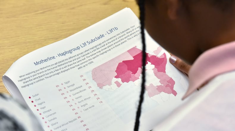 Amariah Caudle, 13, reads the result of her DNA test at Coretta Scott King Young Women’s Leadership Academy. She had based her predictions about her ancestry on stories told by her family members. HYOSUB SHIN / HSHIN@AJC.COM
