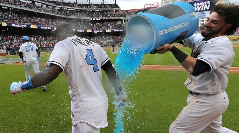 Dansby Swanson dunks Brandon Phillips after he hit a walk off RBI single to beat the Miami Marlins 5-4 Sunday at SunTrust Park.