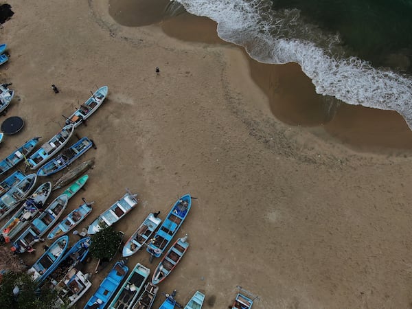 Fishing boats sit on Manzanillo beach for safe keeping after Hurricane Erick hit near Acapulco, Mexico, Thursday, June 19, 2025. (AP Photo/Fernando Llano)