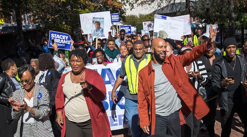 Georgia gubernatorial candidate Stacey Abrams, second from left, is joined by Grammy Award-winning rapper Common, right, attorney Glenda Hatchet and supporters during a Souls to the Polls rally and march in downtown Atlanta in October 2018. Legislation now under consideration in the General Assembly would place limits on weekend early voting that could deter counties from keeping polls open on Sundays. (ALYSSA POINTER/ALYSSA.POINTER@AJC.COM)