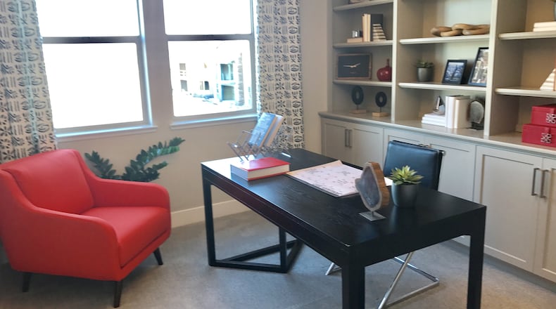 A red accent chair is the springboard for the use of red accents in this home office. (Design Recipes/TNS)