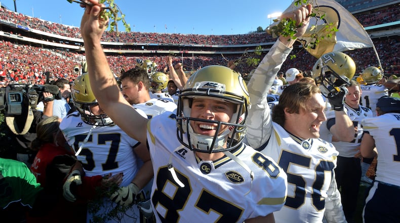 November 26, 2016 Athens - Georgia Tech place kicker Harrison Butker (87) and other players celebrate their 28-27 win over Georgia with a piece of the Sanford Stadium hedges at Sanford Stadium on Saturday, November 26, 2016. HYOSUB SHIN / HSHIN@AJC.COM