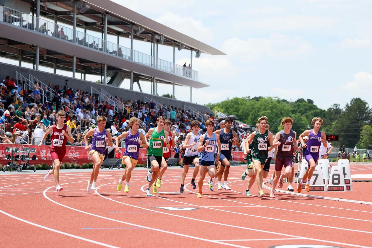 Runners compete in the Class 4A boys 1,600-meter run during the GHSA track and field state championships at the UGA Spec Towns Track on Monday, May 11, 2026, in Athens. (Miguel Martinez/AJC)
