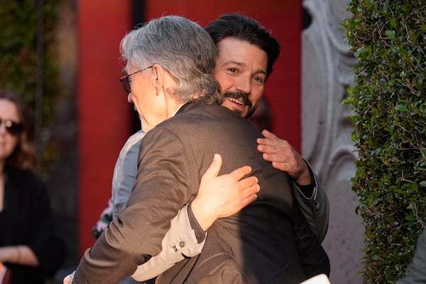 Tony Gilroy, left, and Diego Luna embrace at a launch event of the second season of "Andor" on Monday, April 14, 2025, at the El Capitan Theatre in Los Angeles. (AP Photo/Chris Pizzello)