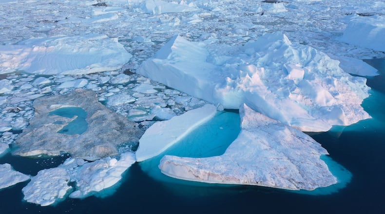 In this aerial view meltwater forms lakes on ice in the Ilulissat Icefjord on August 04, 2019 near Ilulissat, Greenland. The Sahara heat wave that recently sent temperatures to record levels in parts of Europe has also reached Greenland. Climate change is having a profound effect in Greenland, where over the last several decades summers have become longer and the rate that glaciers and the Greenland ice cap are retreating has accelerated. (Photo by Sean Gallup/Getty Images)