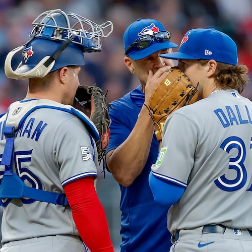 Toronto Blue Jays pitching coach Pete Walker, center, speaks with pitcher Chad Dallas (37) and catcher Tyler Heineman (55) during the third inning of a baseball game against the Atlanta Braves, Thursday, June 4, 2026, in Atlanta. (AP Photo/Erik S. Lesser)