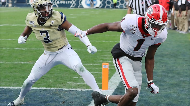Georgia wide reciever George Pickens is pushed out of bounds by Georgia Tech defensive back Tre Swilling defending on a pass from Jake Fromm during the third quarter in a NCAA college football game on Saturday, November 30, 2019, in Atlanta. The two players became entangled in a fight on a following play.   Curtis Compton/ccompton@ajc.com