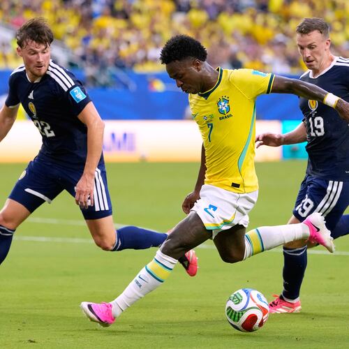 Brazil's Vinicius Junior (7) battles for the ball with with Scotland's Nathan Patterson (22) and Lewis Ferguson (19) during the World Cup Group C soccer match between Scotland and Brazil in Miami Gardens, Fla., Wednesday, June 24, 2026. (AP Photo/Rebecca Blackwell)