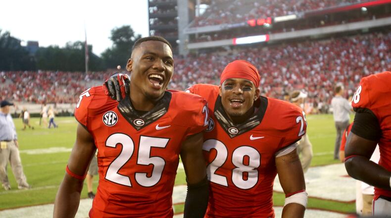 Josh Harvey-Clemons (25) and Tray Matthews (28) celebrate after Georgia's win over South Carolina on September 7, 2013. Both have left the program since.