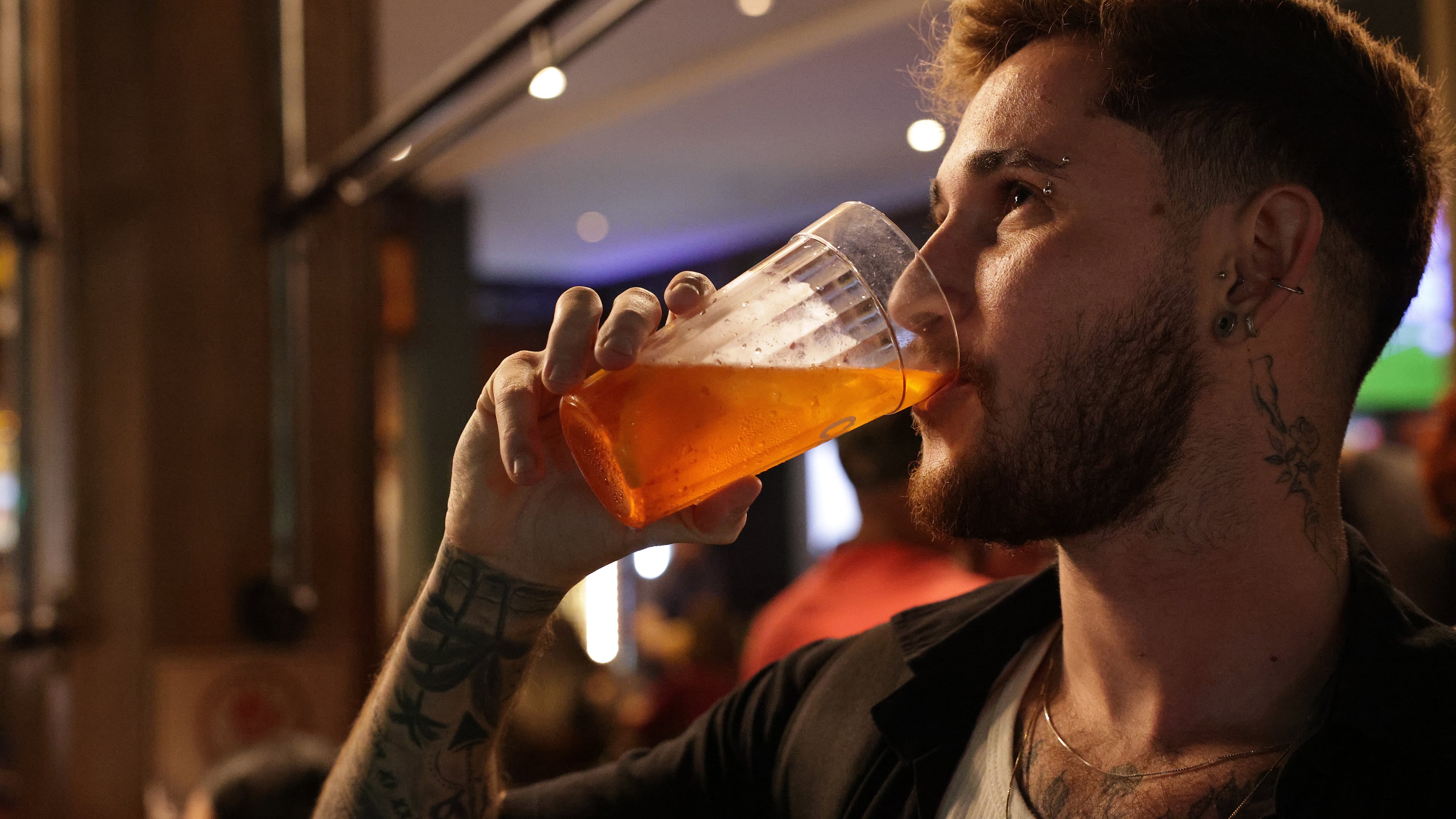Gustavo Candido drinks liquor at a bar in Sao Paulo, Friday, Oct. 3, 2025. (AP Photo/Ettore Chiereguini)