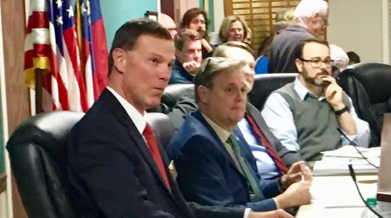 (left to right) Avondale Estates City Manager Clai Brown, Mayor Jonathan Elmore, Commissioners Terry Giager (partly hidden) and Brian Fisher during Monday’s city commission meeting. Bill Banks for the AJC