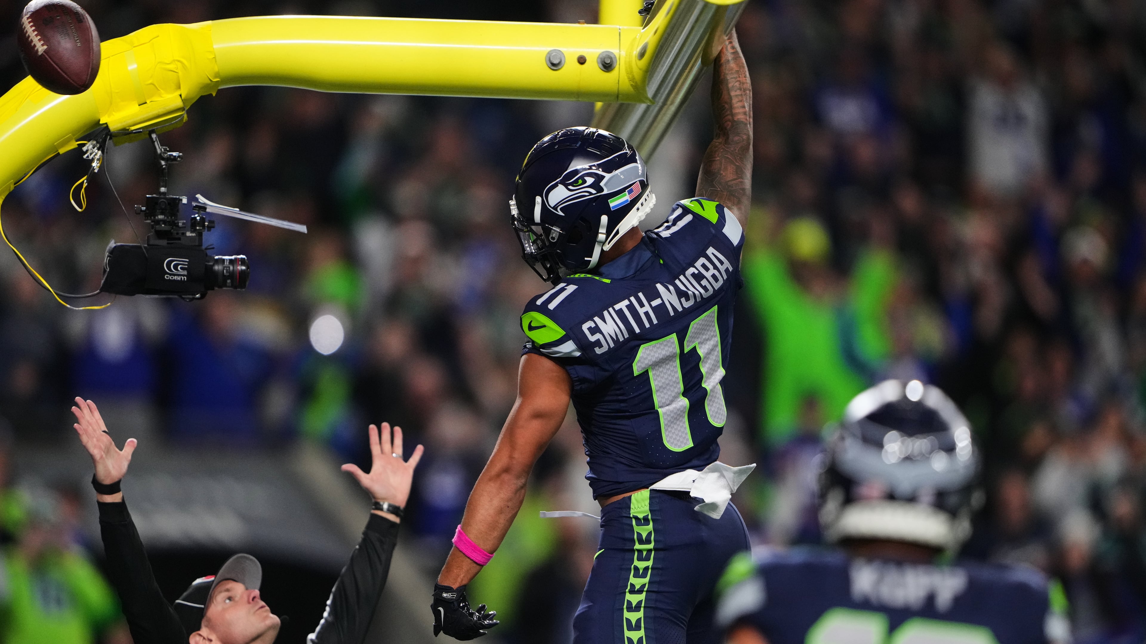 Seattle Seahawks wide receiver Jaxon Smith-Njigba (11) celebrates his touchdown catch as an official signals and looks on in the first half of an NFL football game Monday, Oct. 20, 2025, in Seattle. (AP Photo/Lindsey Wasson)